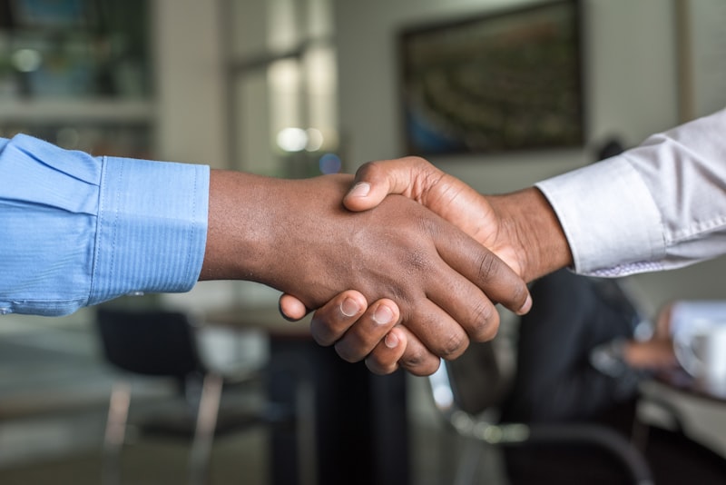 Two people shaking hands after reaching an agreement